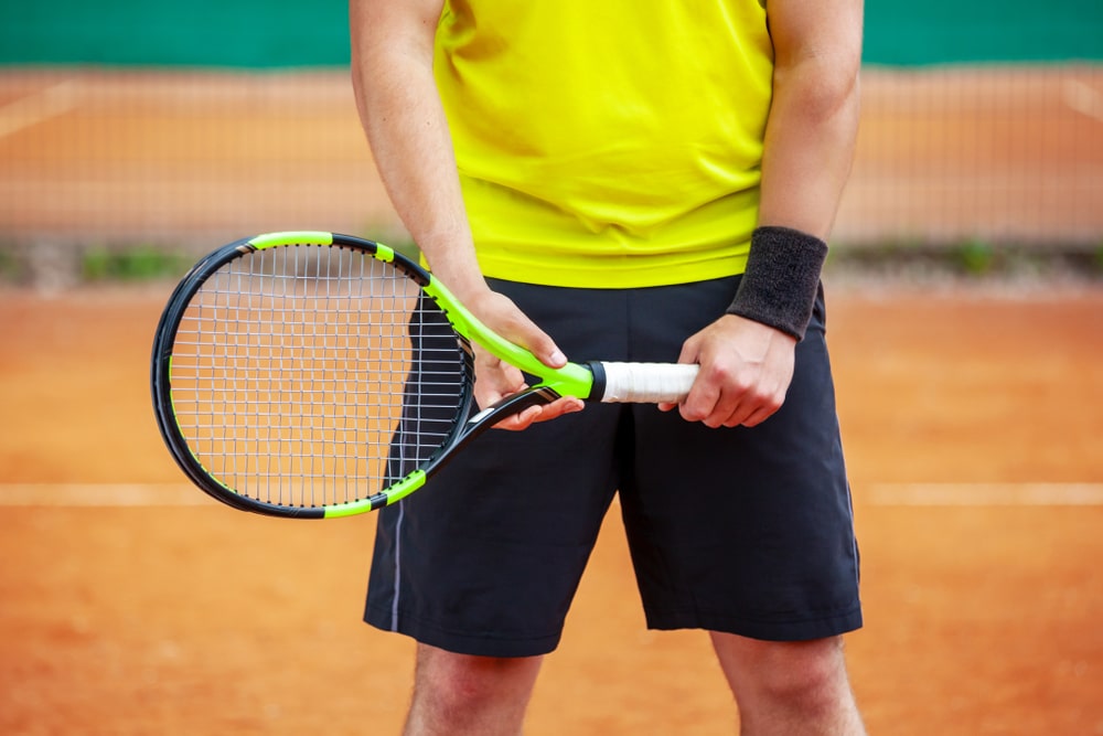 A view of a person gripping a tennis racket