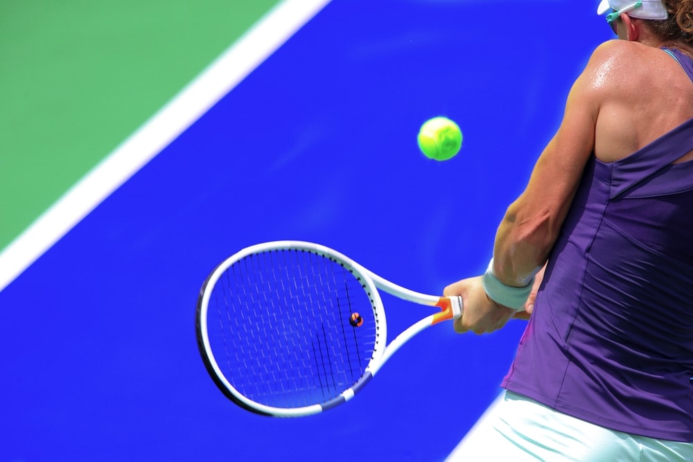 A view of a person hitting a backhand tennis shot