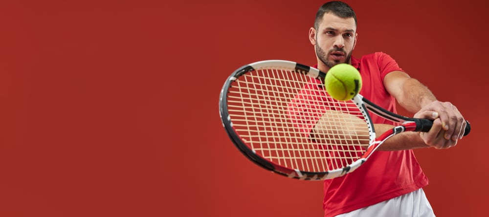 A view of a person playing tennis with a racket