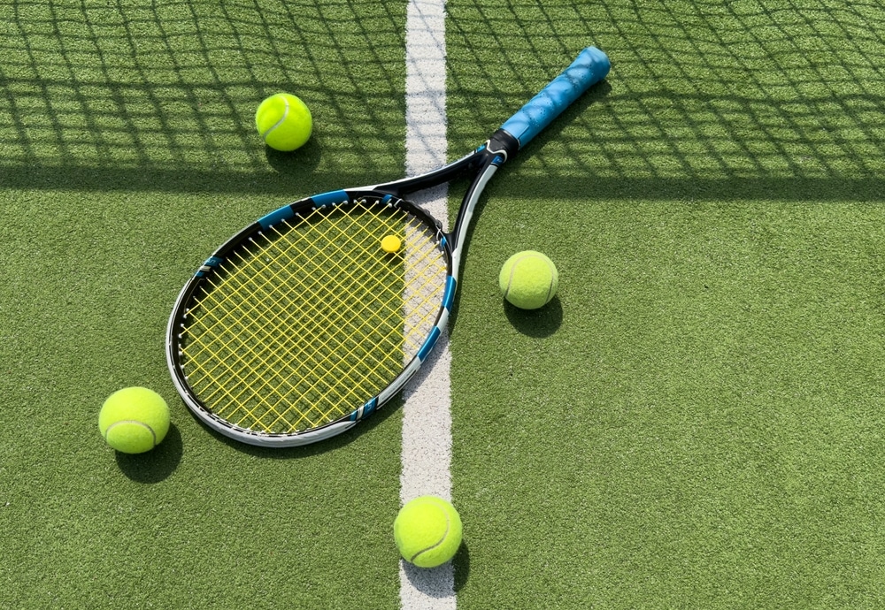 A view of a tennis racket with balls