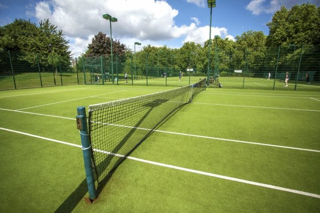 a green tennis court net is all set for the game