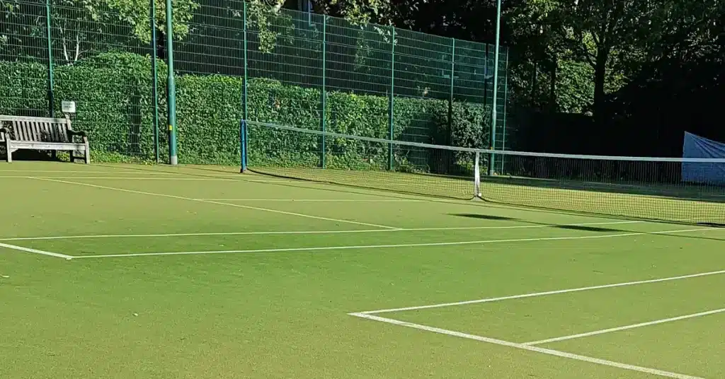 clean and maintained green tennis court