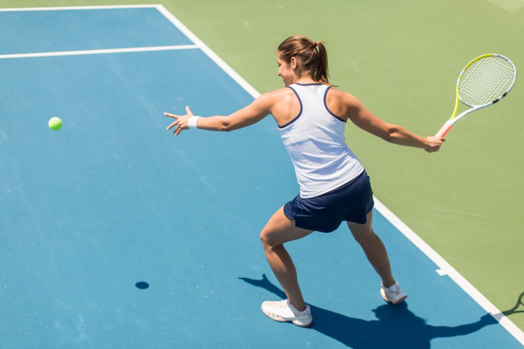 girl all set for hitting the ball in tennis court