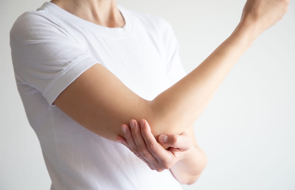 Woman Holding Her Elbow In Pain