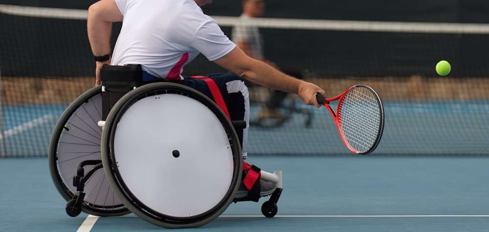 Men On Wheelchair Playing Tennis On Tennis Court