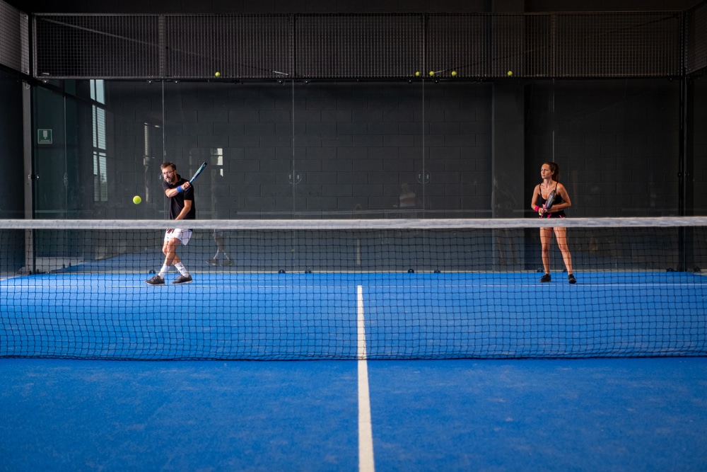 Mixed Padel Match In A Blue Grass Padel Court Indoor