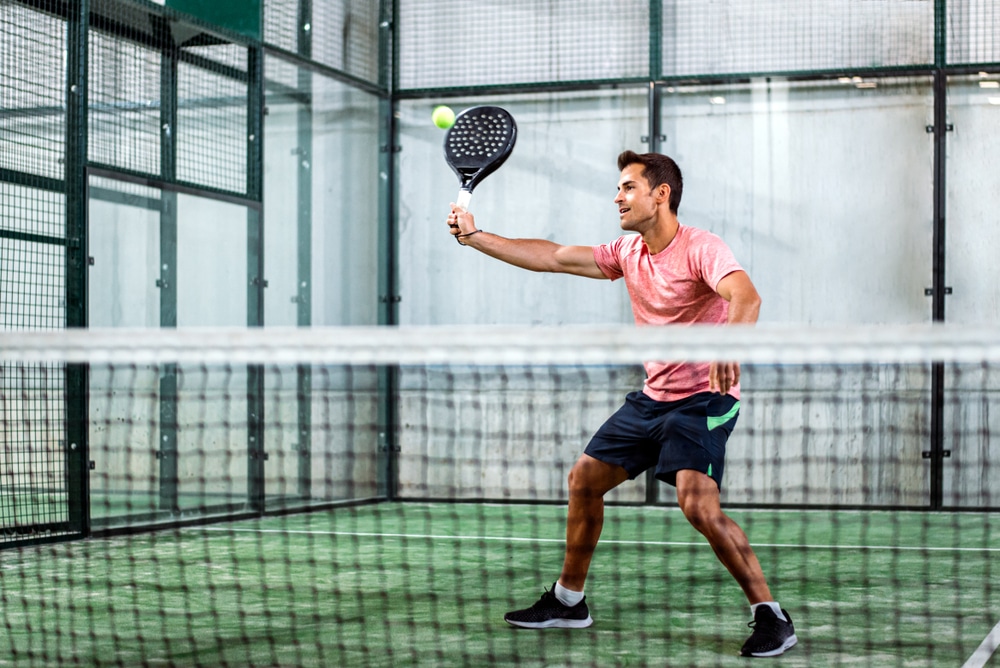 a man playing indoor tennis 