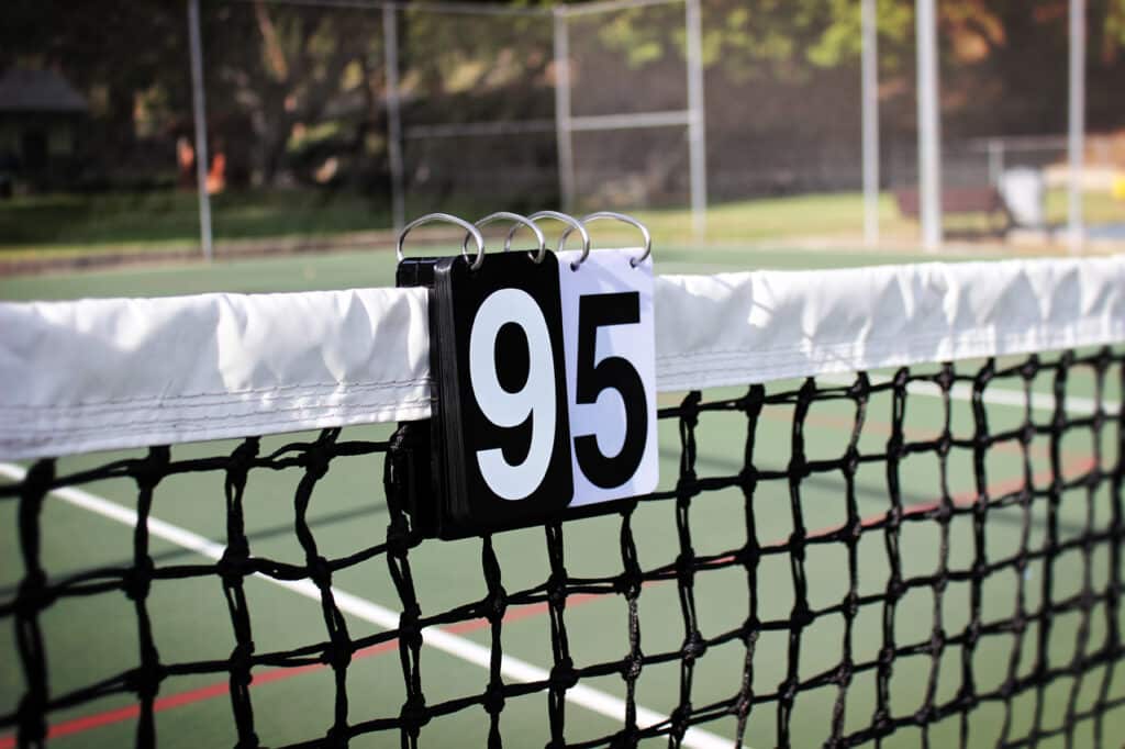 A view of a tennis score set hung over a net