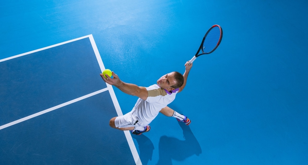 During Game Concentration Portrait Of Male Professional Tennis Player Serving