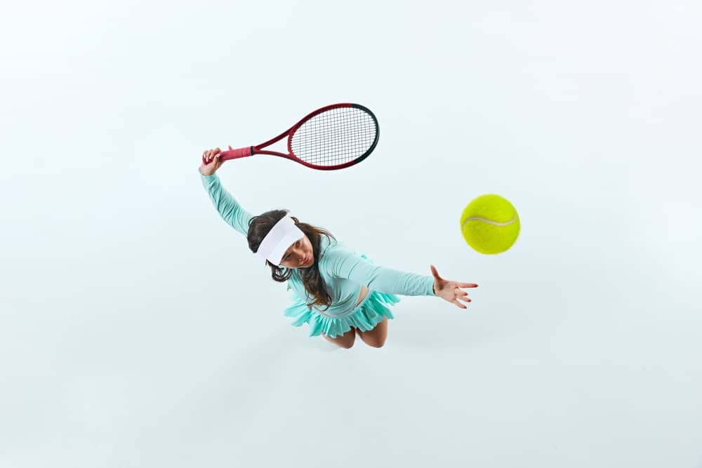 Aerial view of female tennis player serving the shot