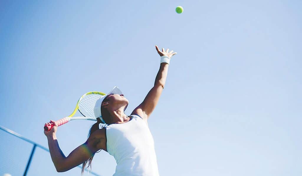 female player hitting serve shot