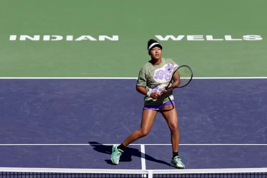 female player holding racket in a court