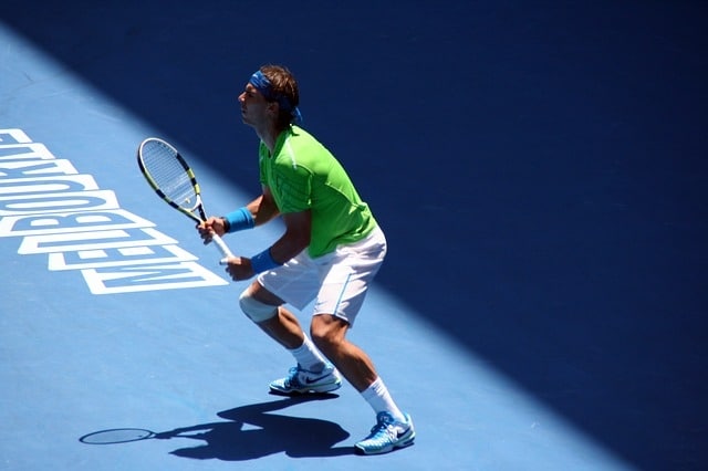 male player hitting serve return shot