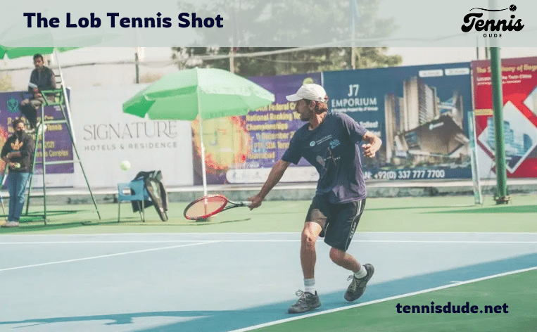 male player hitting the lob tennis shot in the court