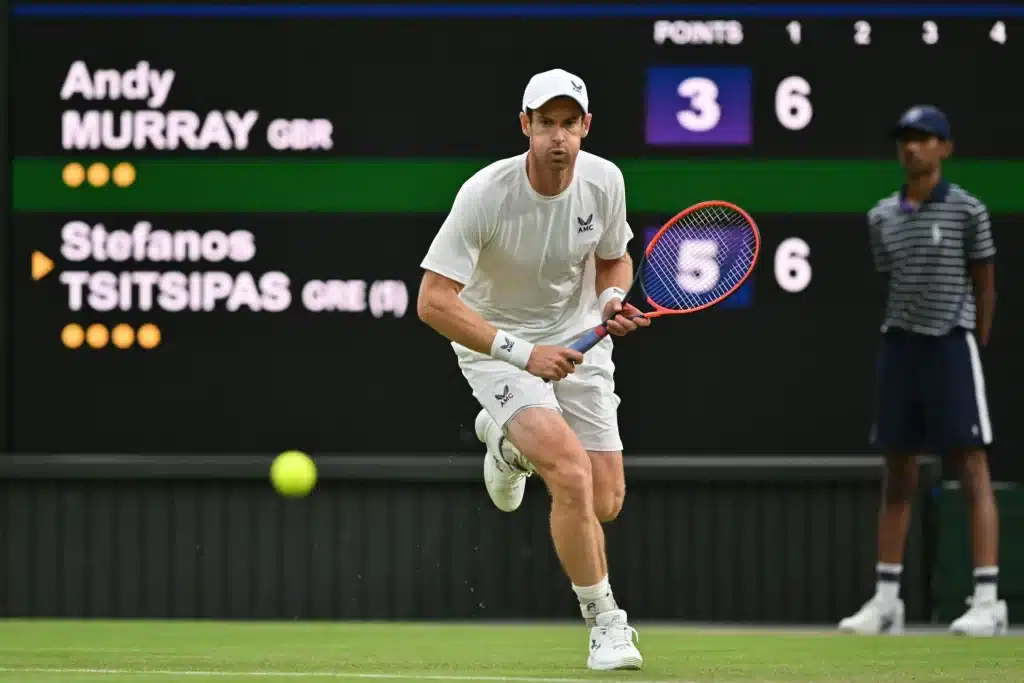 male players playing a shot in court referee standing behind