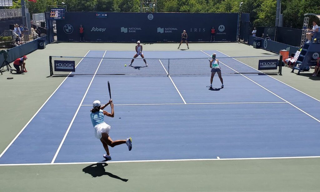 players playing doubles tennis