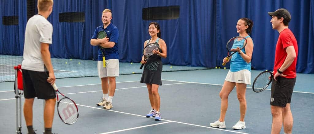 tennis players talking to each other on court