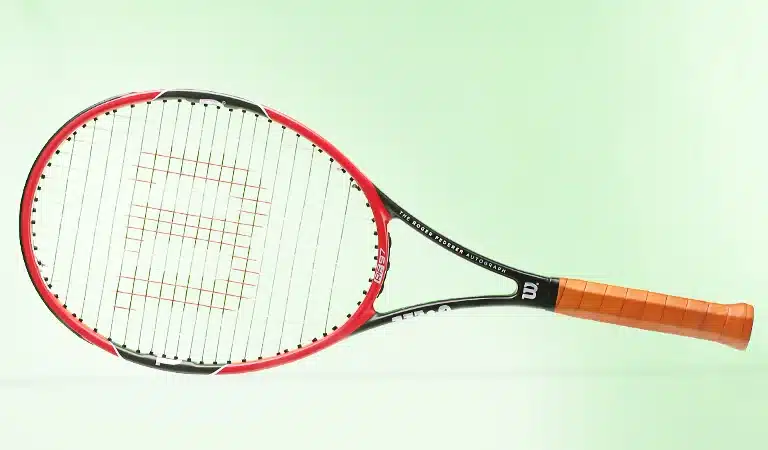 wilso pro RF racket in front of a green background